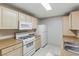 Functional kitchen with white appliances and tile floors, designed for easy meal preparation at 8250 N Grand Canyon Dr # 1123, Las Vegas, NV 89166