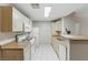 Clean kitchen with white appliances, tile floors, and a breakfast bar for convenience at 8250 N Grand Canyon Dr # 1123, Las Vegas, NV 89166