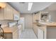 Well-lit kitchen featuring white appliances and ample cabinet space at 8250 N Grand Canyon Dr # 1123, Las Vegas, NV 89166