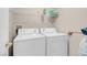 Modern laundry room features white washer and dryer units with shelving at 8250 N Grand Canyon Dr # 1123, Las Vegas, NV 89166