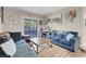 Well-lit living room featuring modern decor, a sliding glass door, and comfortable seating at 8250 N Grand Canyon Dr # 1123, Las Vegas, NV 89166