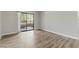 Bright living room with sliding glass doors to the patio and wood flooring at 8250 N Grand Canyon Dr # 1123, Las Vegas, NV 89166