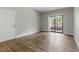 Open living room featuring wood floors, a balcony, and lots of natural light at 8250 N Grand Canyon Dr # 1123, Las Vegas, NV 89166