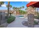 View of community pool showcasing lush landscaping and stone design at 8250 N Grand Canyon Dr # 1123, Las Vegas, NV 89166
