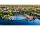 Aerial view of community pool and recreation center by the lake, surrounded by lush landscaping at 8320 Opal Cove Dr, Las Vegas, NV 89128