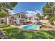 Backyard featuring a sparkling pool, patio, manicured lawn and mature trees at 8320 Opal Cove Dr, Las Vegas, NV 89128