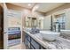 Bathroom boasting dual vessel sinks, granite countertop, and an adjacent bedroom at 8320 Opal Cove Dr, Las Vegas, NV 89128