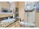 Well-lit bathroom with granite vanity and glass enclosed shower, provides a luxurious feel at 8320 Opal Cove Dr, Las Vegas, NV 89128