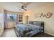 Bedroom featuring a window, fan, hardwood floors, and neutral décor at 8320 Opal Cove Dr, Las Vegas, NV 89128