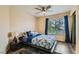 Bedroom with a ceiling fan, ample natural light, and modern gray floors at 8320 Opal Cove Dr, Las Vegas, NV 89128