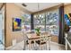 Dining area with backyard view and access, features a modern chandelier and neutral decor at 8320 Opal Cove Dr, Las Vegas, NV 89128