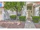 Charming front entrance with a well-maintained walkway and beautiful landscaping surrounding the front at 8320 Opal Cove Dr, Las Vegas, NV 89128