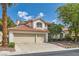 Charming home with a red tile roof, a spacious three-car garage, and mature landscaping at 8320 Opal Cove Dr, Las Vegas, NV 89128