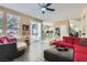 Open living room boasts wood floors, comfortable seating, and seamless access to outdoor pool at 8320 Opal Cove Dr, Las Vegas, NV 89128