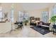 Bright living room with a vaulted ceiling, neutral tones, and tile flooring for a modern aesthetic at 8320 Opal Cove Dr, Las Vegas, NV 89128