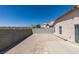 View of the house and backyard with a block wall and patio space at 8877 Perfect Diamond Ct, Las Vegas, NV 89129