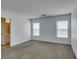 Bright bedroom with neutral walls, gray carpet, and natural light from two large windows and view of the bathroom at 8877 Perfect Diamond Ct, Las Vegas, NV 89129