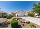 Single story home with a two car garage and desert landscaping at 8877 Perfect Diamond Ct, Las Vegas, NV 89129