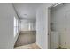 Hallway with a wood floor, laundry closet, and access to the living room at 8877 Perfect Diamond Ct, Las Vegas, NV 89129