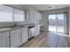 Bright kitchen featuring white cabinets, stainless steel dishwasher, and sliding glass door to the patio at 8877 Perfect Diamond Ct, Las Vegas, NV 89129