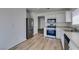 Bright kitchen features stainless appliances, white cabinets and light wood-look flooring at 8877 Perfect Diamond Ct, Las Vegas, NV 89129