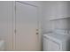 This laundry room includes a washer and dryer, a door to the garage, and shelving at 8877 Perfect Diamond Ct, Las Vegas, NV 89129