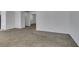 Spacious living room featuring neutral carpet, bright windows, and white walls at 8877 Perfect Diamond Ct, Las Vegas, NV 89129