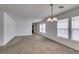Spacious living room featuring neutral carpet and multiple windows for ample natural light at 8877 Perfect Diamond Ct, Las Vegas, NV 89129