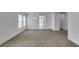 Spacious living room featuring neutral carpet, bright windows, and modern lighting at 8877 Perfect Diamond Ct, Las Vegas, NV 89129