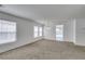 Spacious living room featuring neutral carpet, bright windows, and modern lighting at 8877 Perfect Diamond Ct, Las Vegas, NV 89129