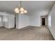 Bright living room featuring neutral carpet and modern chandelier at 8877 Perfect Diamond Ct, Las Vegas, NV 89129