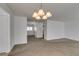Spacious living room featuring neutral carpet and modern chandelier at 8877 Perfect Diamond Ct, Las Vegas, NV 89129