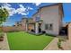 Large backyard with artificial turf is perfect for relaxation and outdoor entertaining at 8898 Sasquatch Run Ave, Las Vegas, NV 89166