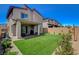 Spacious backyard with lush artificial grass, covered patio, and low-maintenance landscaping at 8898 Sasquatch Run Ave, Las Vegas, NV 89166