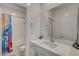 Bathroom features a tub-shower combo, large mirror over the vanity, and modern fixtures at 8898 Sasquatch Run Ave, Las Vegas, NV 89166
