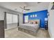 Comfortable bedroom with a large bed, ceiling fan, and ample natural light from a window at 8898 Sasquatch Run Ave, Las Vegas, NV 89166