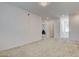 Bright bonus room featuring neutral carpeting, a ceiling light and multiple entryways at 8898 Sasquatch Run Ave, Las Vegas, NV 89166