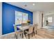 Bright dining room featuring an accent wall and a sliding door to the backyard at 8898 Sasquatch Run Ave, Las Vegas, NV 89166