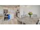 Open floor plan with dining area, kitchen featuring stainless appliances and center island at 8898 Sasquatch Run Ave, Las Vegas, NV 89166
