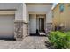 Inviting entryway with stone pillars, brick pathway, and a modern front door at 8898 Sasquatch Run Ave, Las Vegas, NV 89166