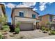 Charming home with stone accents, a two-car garage, and desert landscaping at 8898 Sasquatch Run Ave, Las Vegas, NV 89166