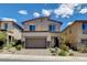 Beautiful two-story home featuring stylish design elements and a well-manicured front yard at 8898 Sasquatch Run Ave, Las Vegas, NV 89166