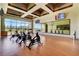 Modern fitness center with stationary bikes, floor to ceiling windows with beautiful golf course views and mounted televisions at 8898 Sasquatch Run Ave, Las Vegas, NV 89166