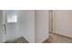Clean hallway with neutral carpeting, leading to doorways and a bright window at 8898 Sasquatch Run Ave, Las Vegas, NV 89166