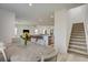 Spacious open floor plan with dining area, kitchen, living room and stairway at 8898 Sasquatch Run Ave, Las Vegas, NV 89166