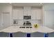 Bright kitchen featuring a quartz countertop island and stainless steel appliances at 8898 Sasquatch Run Ave, Las Vegas, NV 89166