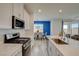 Modern kitchen with white cabinets, an island with seating, and stainless steel appliances at 8898 Sasquatch Run Ave, Las Vegas, NV 89166