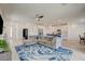Open-concept living area with kitchen and dining space, featuring hardwood floors and recessed lighting at 8898 Sasquatch Run Ave, Las Vegas, NV 89166