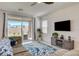 Comfortable living room with sliding glass doors and a stylish blue marble rug at 8898 Sasquatch Run Ave, Las Vegas, NV 89166