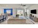 Cozy living room with a comfortable couch and sliding glass doors to the backyard at 8898 Sasquatch Run Ave, Las Vegas, NV 89166